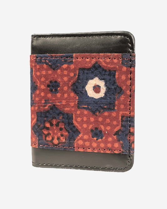 Cardholder with an ajrak block print patterned front and brown leather sides on a white background