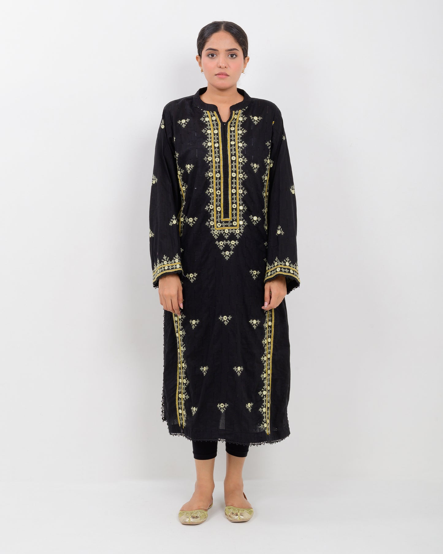 Woman wearing a black balochi embroidered kurta shirt with yellow patterns on a white background