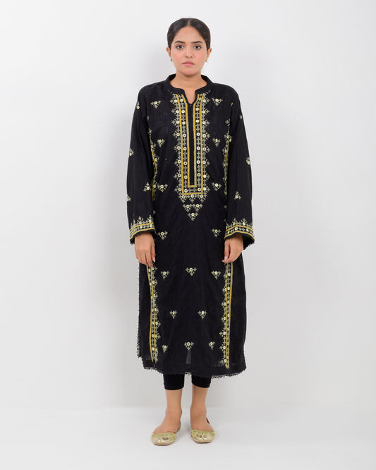 Woman wearing a black balochi embroidered kurta shirt with yellow patterns on a white background
