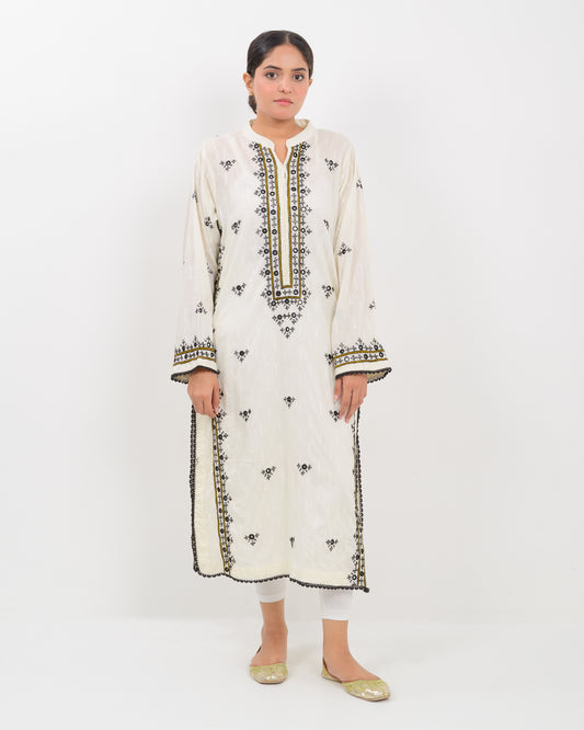 Woman wearing a white balochi embroidered kurta shirt with black patterns on a white background