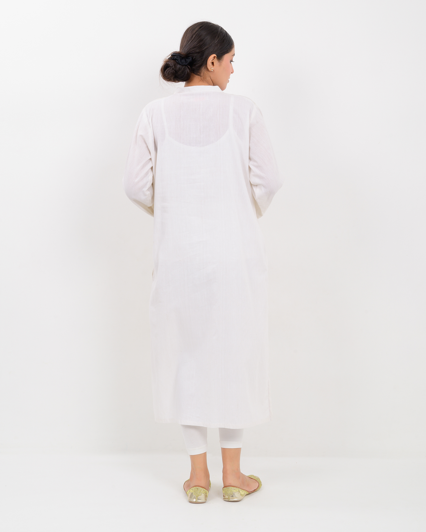Woman wearing a white Balochi Embroidery Shirt with white plazo pants