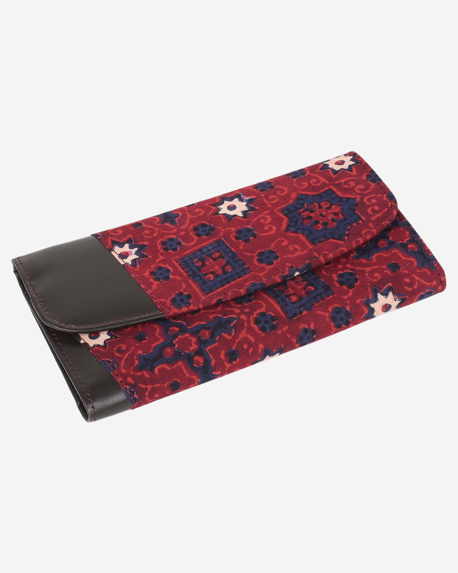Red and blue patterned clutch bag with a leather flap on a white background
