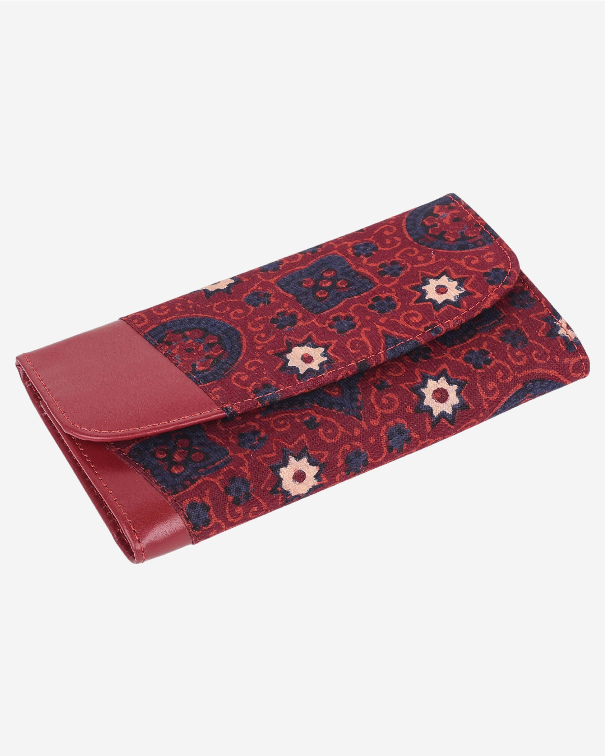 Red and blue patterned clutch bag with a leather flap on a white background