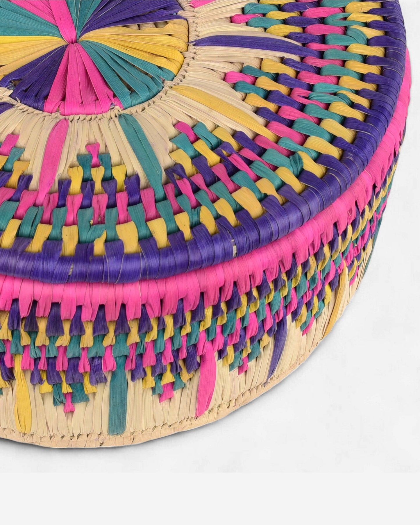 Colorful woven basket with a circular design on a white background