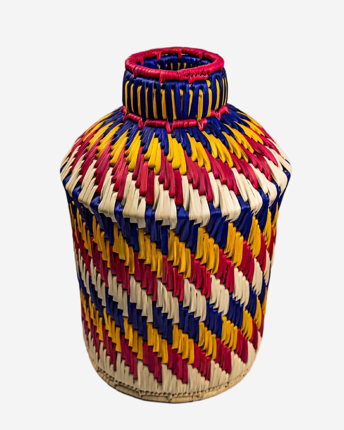 Colorful woven vase with a zigzag pattern on a white background