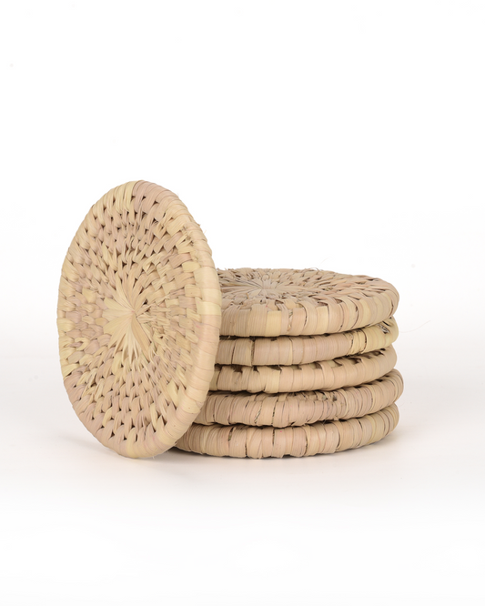 Set of four woven coasters on a white background