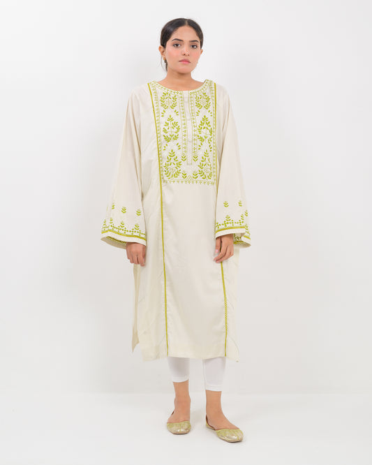 Woman wearing a light green kachi sui embroidery shirt on a white background