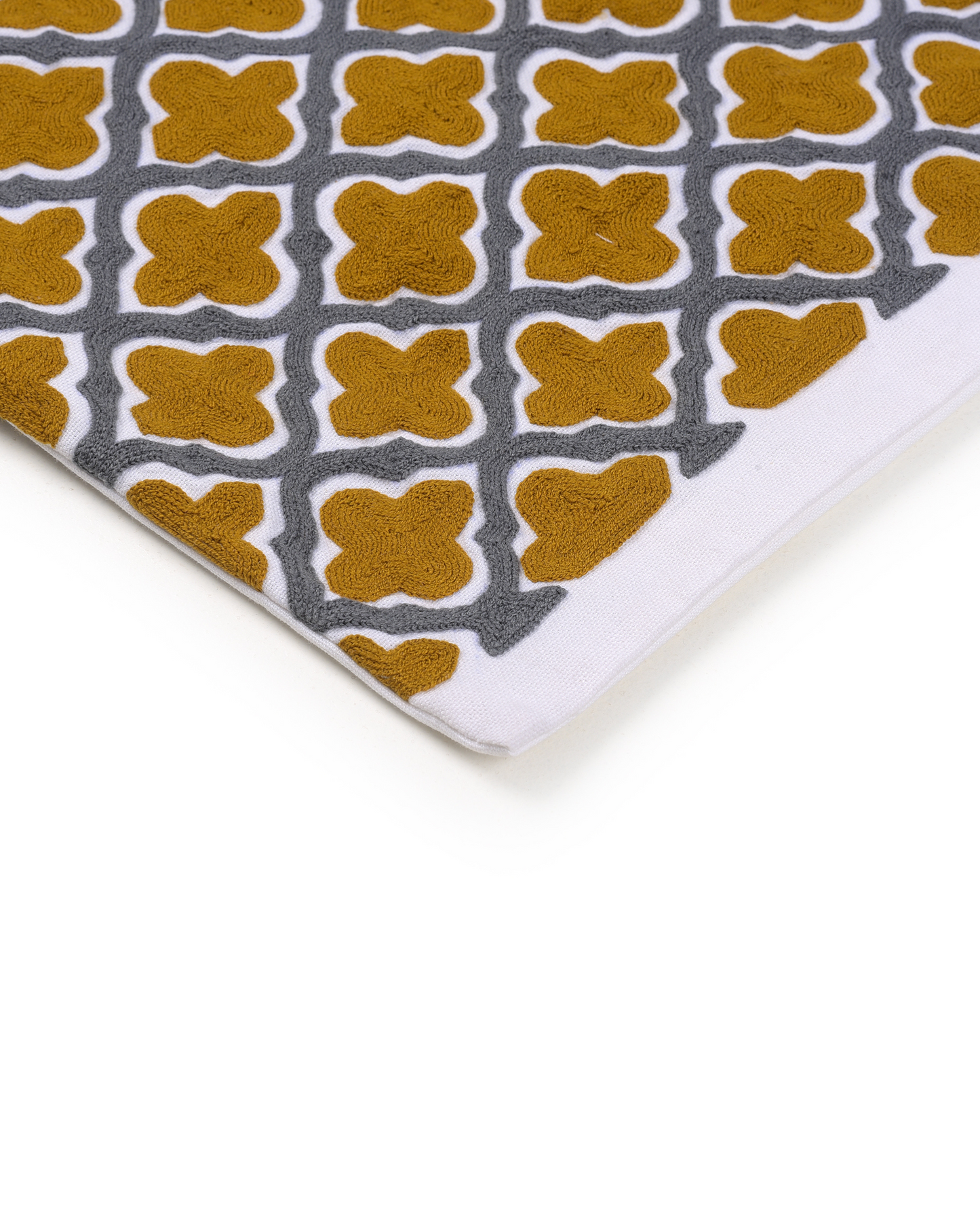Decorative pillow with yellow and gray pattern on a gray sofa