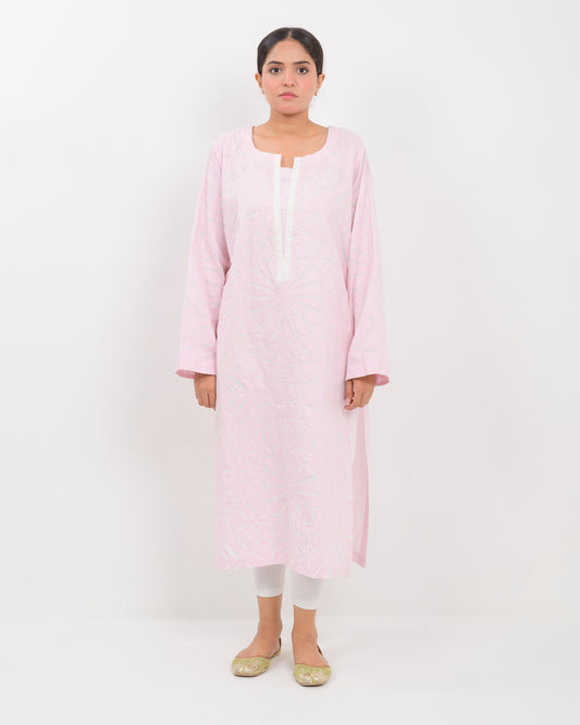 A woman wearing a light pink Applique cutwork Shirt with a white pants on a white background