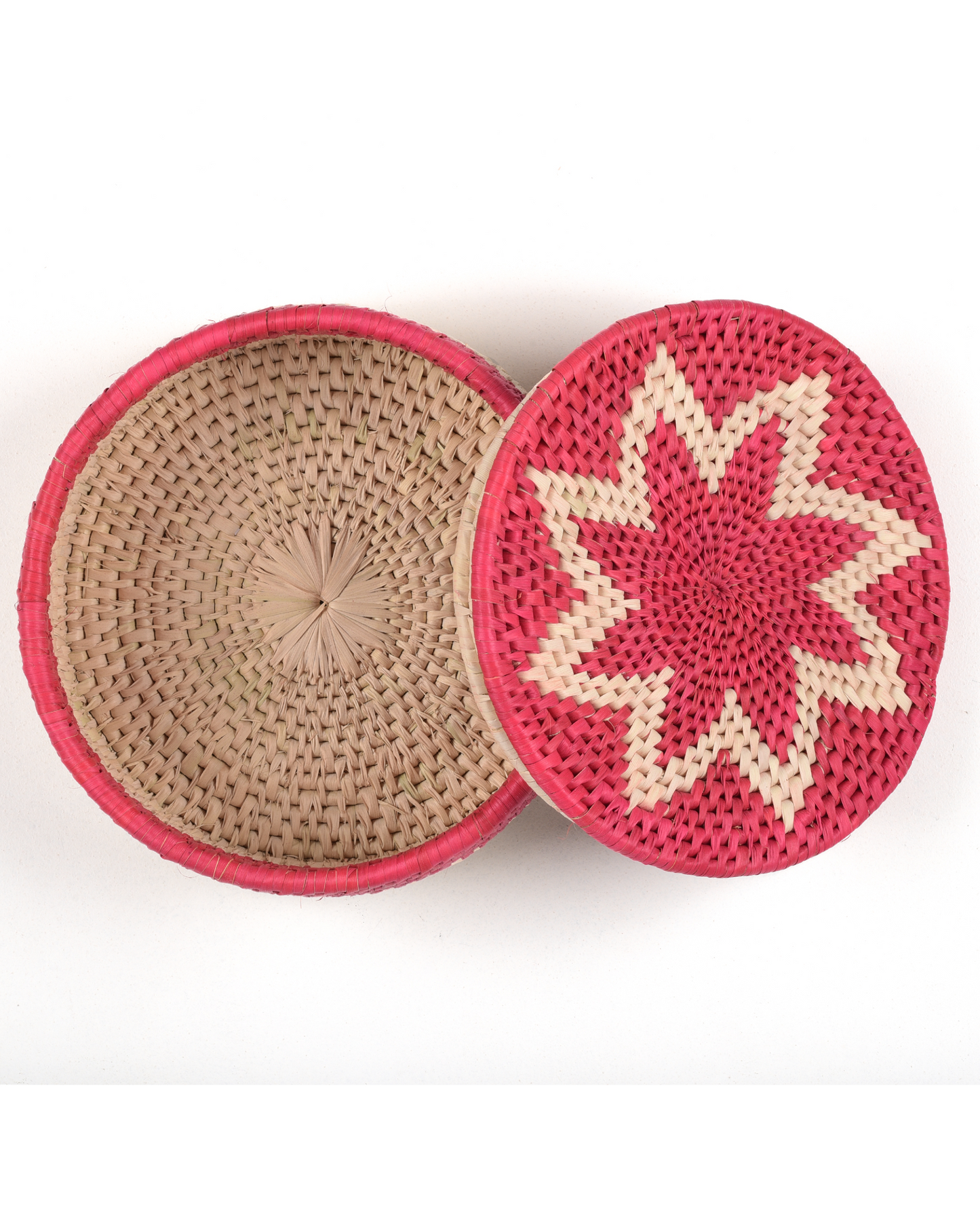 Round woven container with pink rim and star pattern on a white background