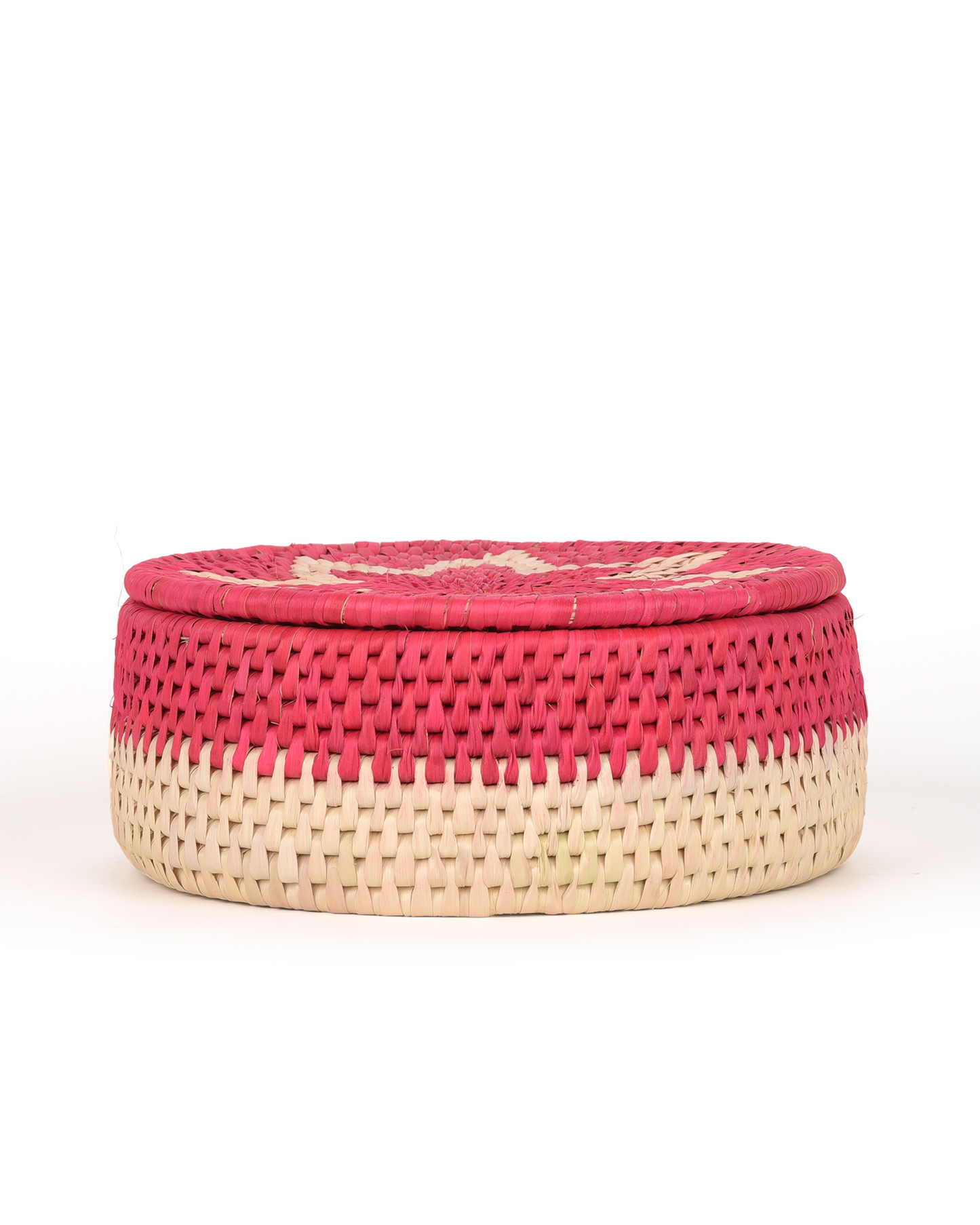 Woven basket with pink top and beige bottom on a white background