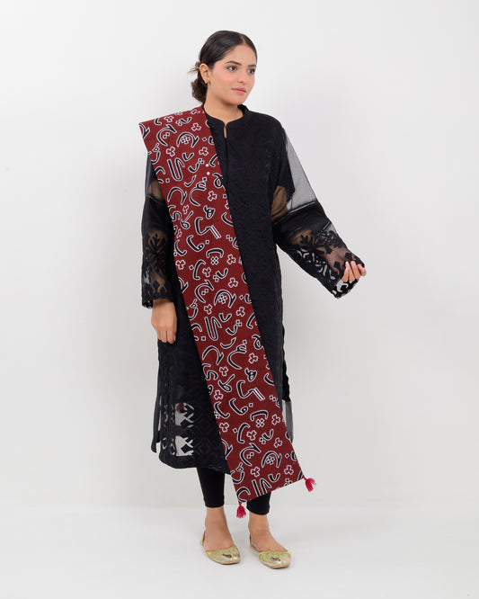 A woman wearing a black outfit with a Red color Sindhi script, stole on a white background.