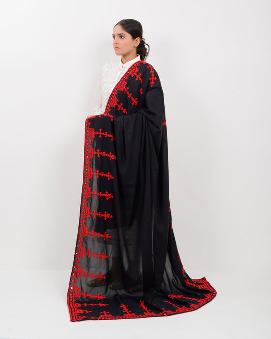 Woman wearing a black color with red hurmich embroidery shawl on a white background