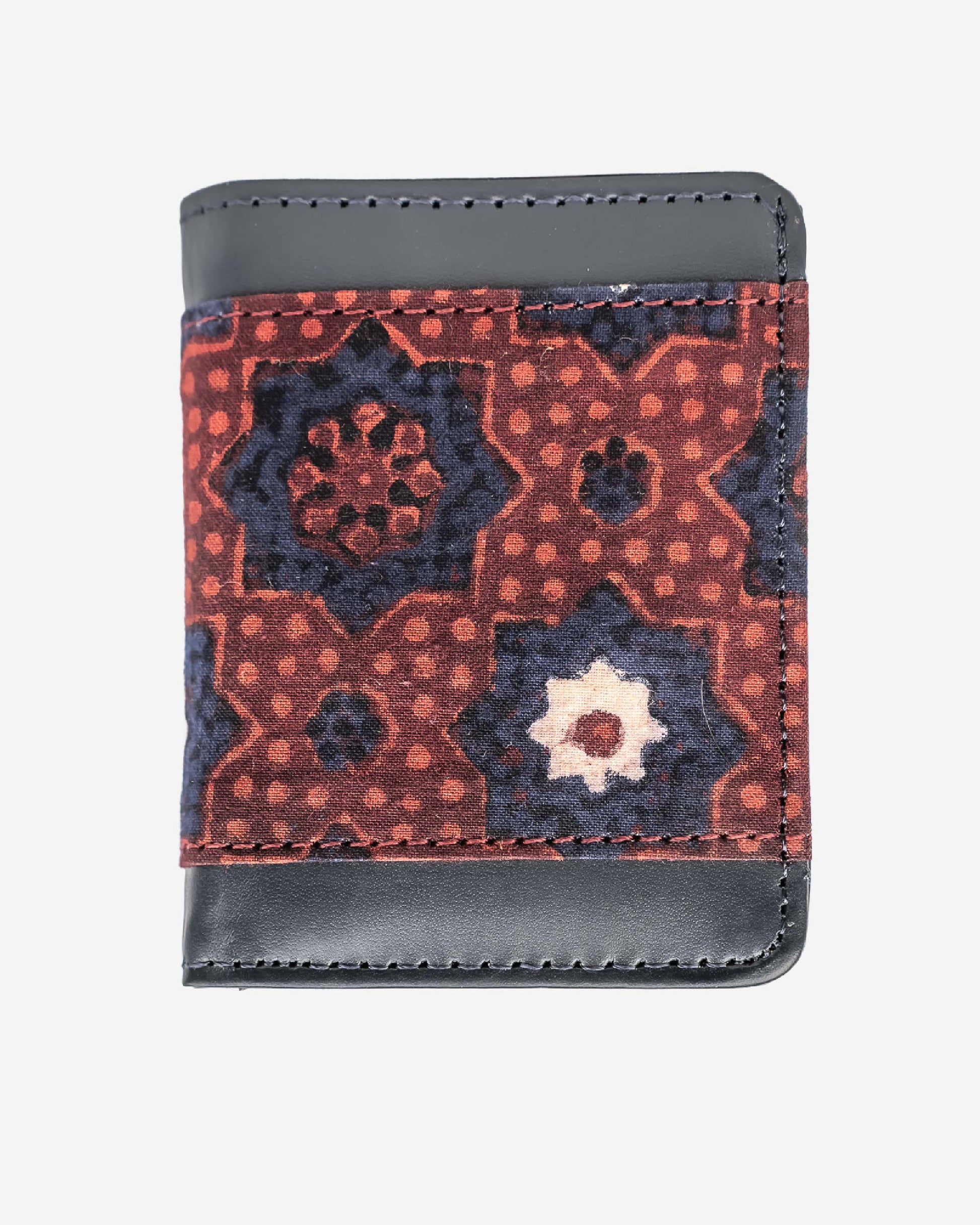 Cardholder with an ajrak block print patterned front and brown leather sides on a white background