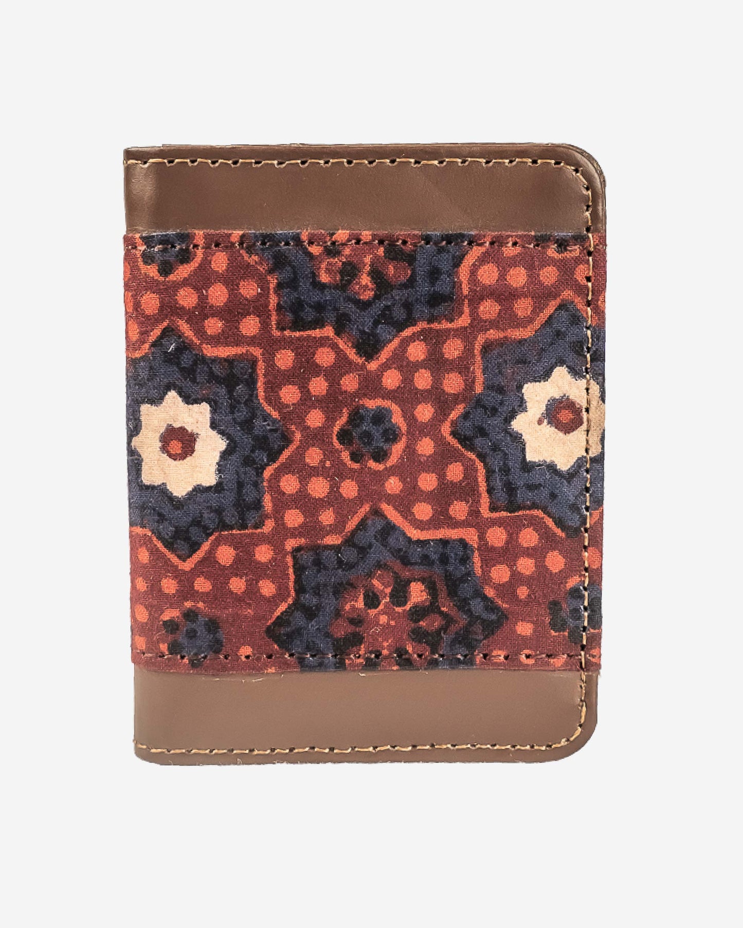 Cardholder with an ajrak block print patterned front and brown leather sides on a white background
