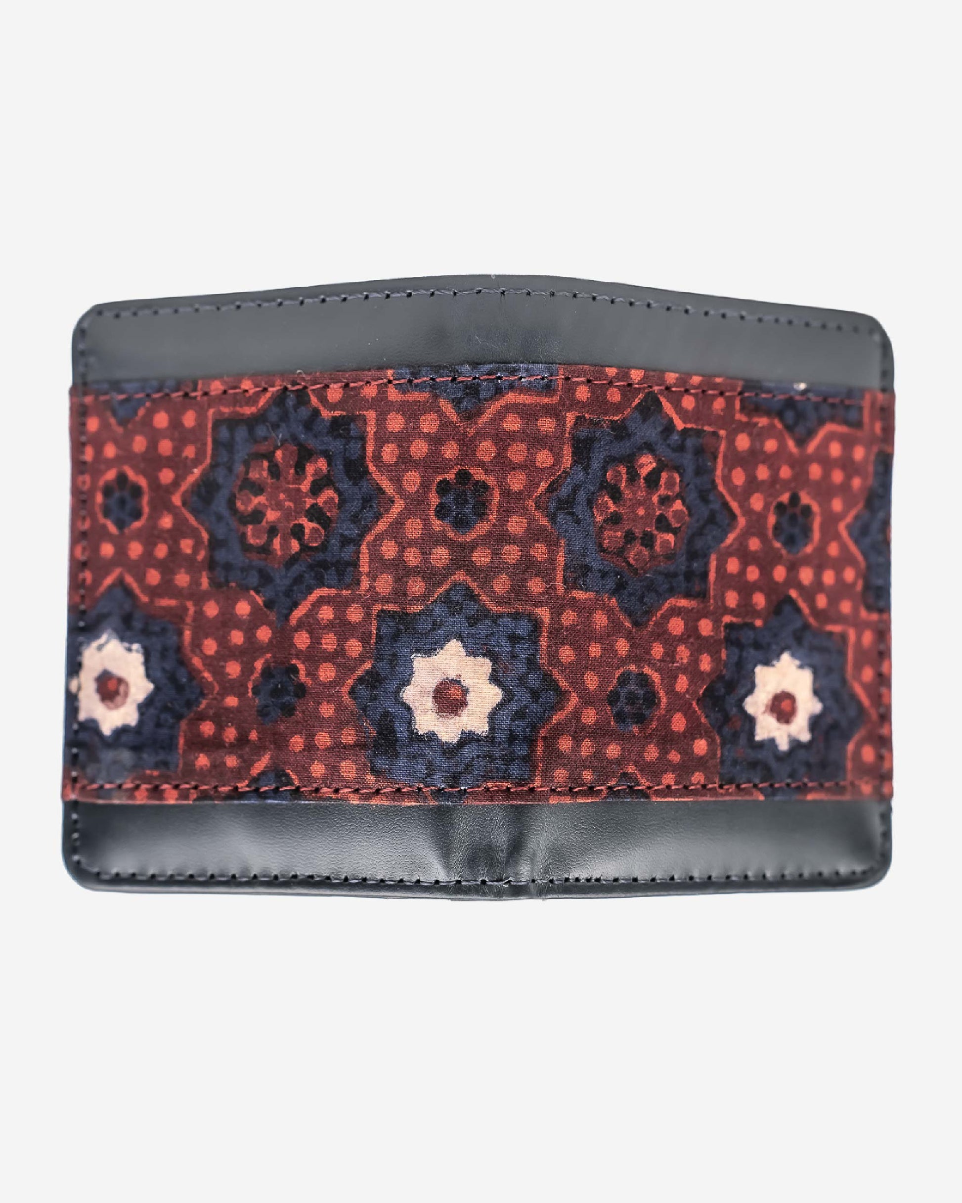 Cardholder with an ajrak block print patterned front and brown leather sides on a white background