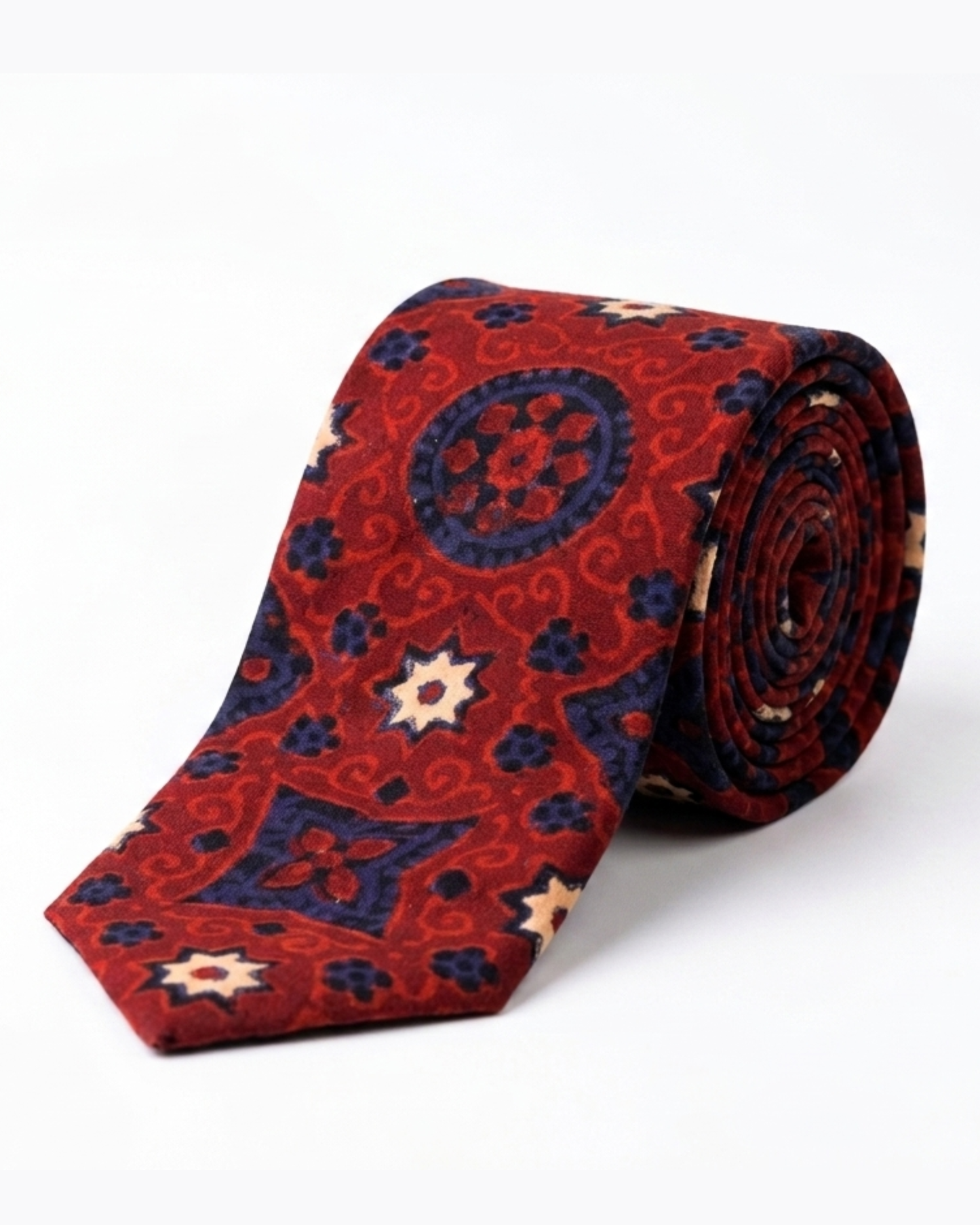 Ajrak hand block print cotton tie in crimson red with indigo geometric medallions and floral motifs, handcrafted in Sindh Pakistan