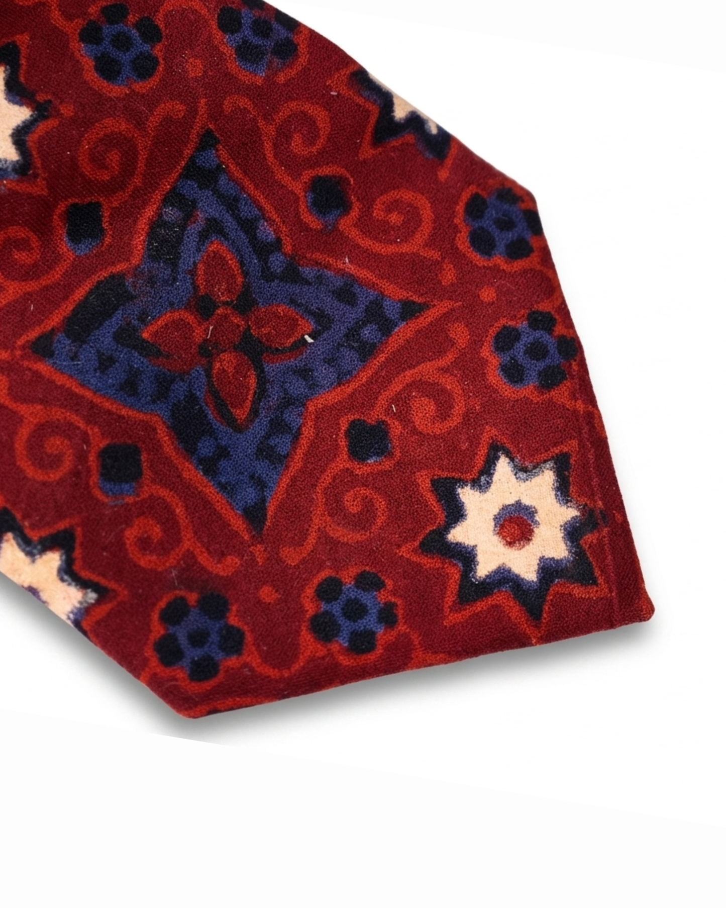 Ajrak hand block print cotton tie in crimson red with indigo geometric medallions and floral motifs, handcrafted in Sindh Pakistan