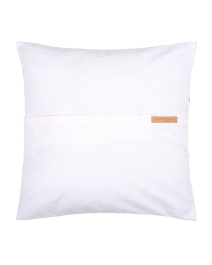 Yellow pillow with white pattern on a gray couch