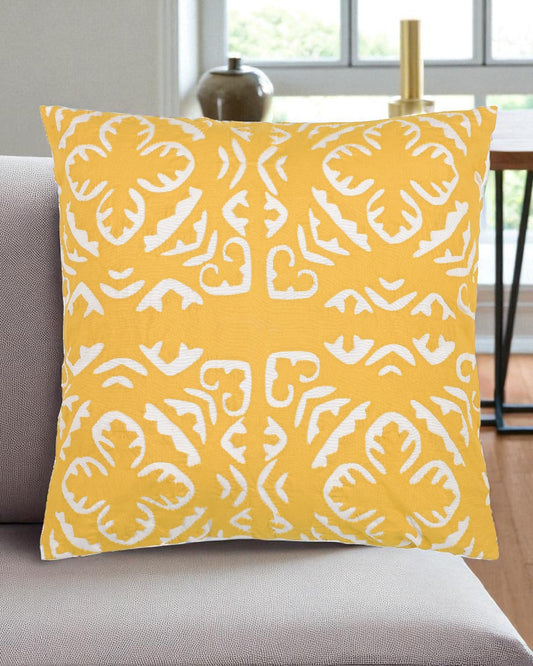 Yellow pillow with white pattern on a gray couch
