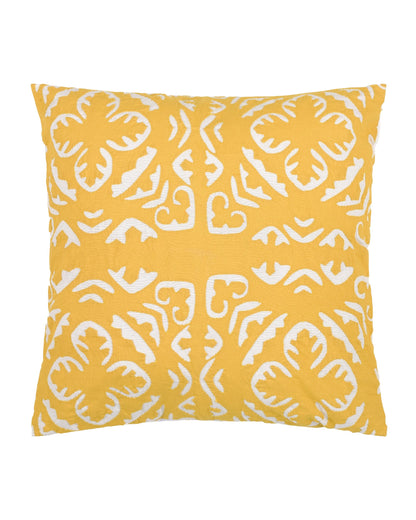 Yellow pillow with white pattern on a gray couch