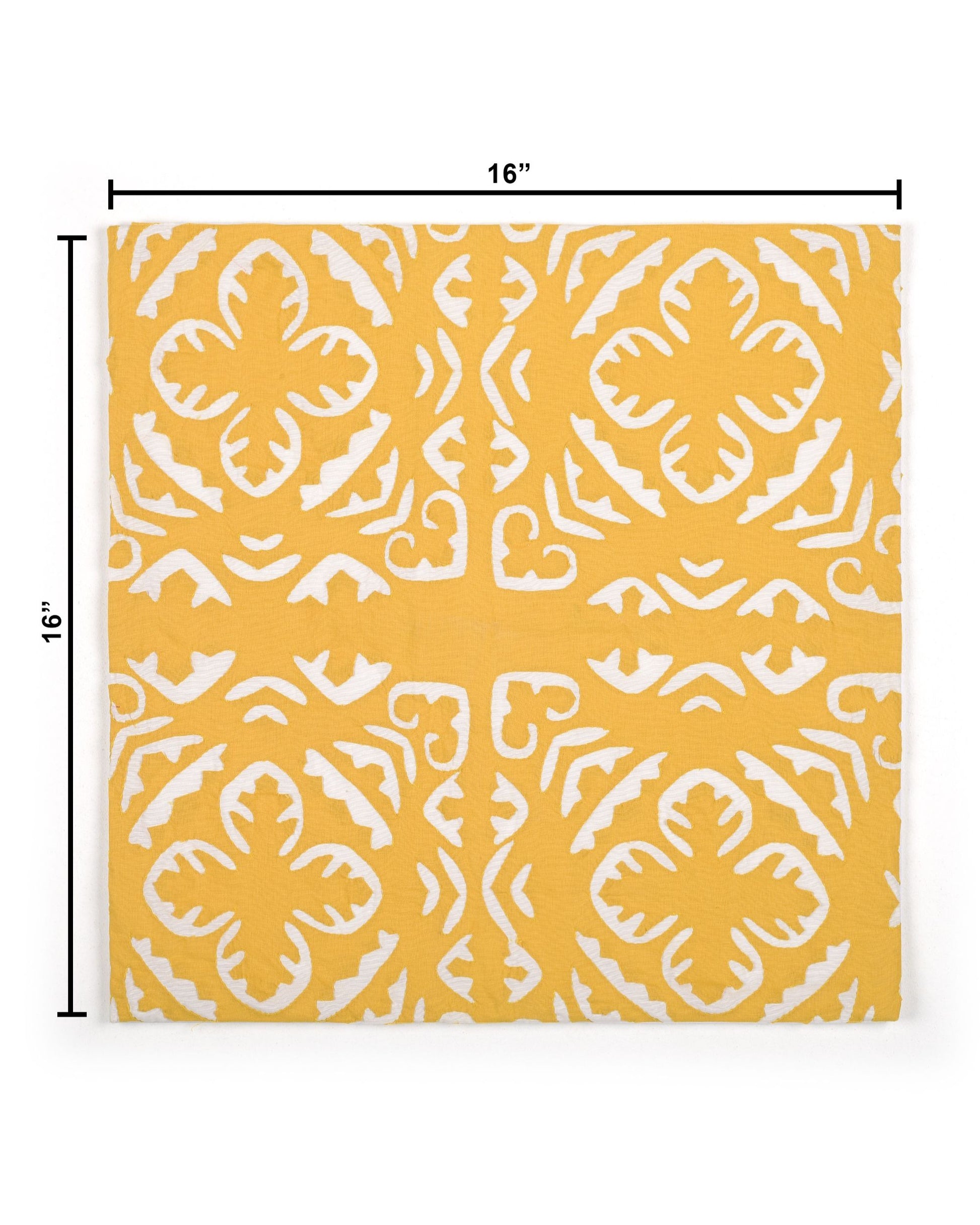 Yellow pillow with white pattern on a gray couch