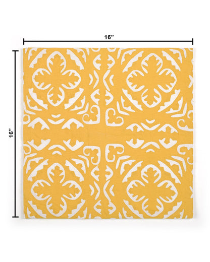 Yellow pillow with white pattern on a gray couch