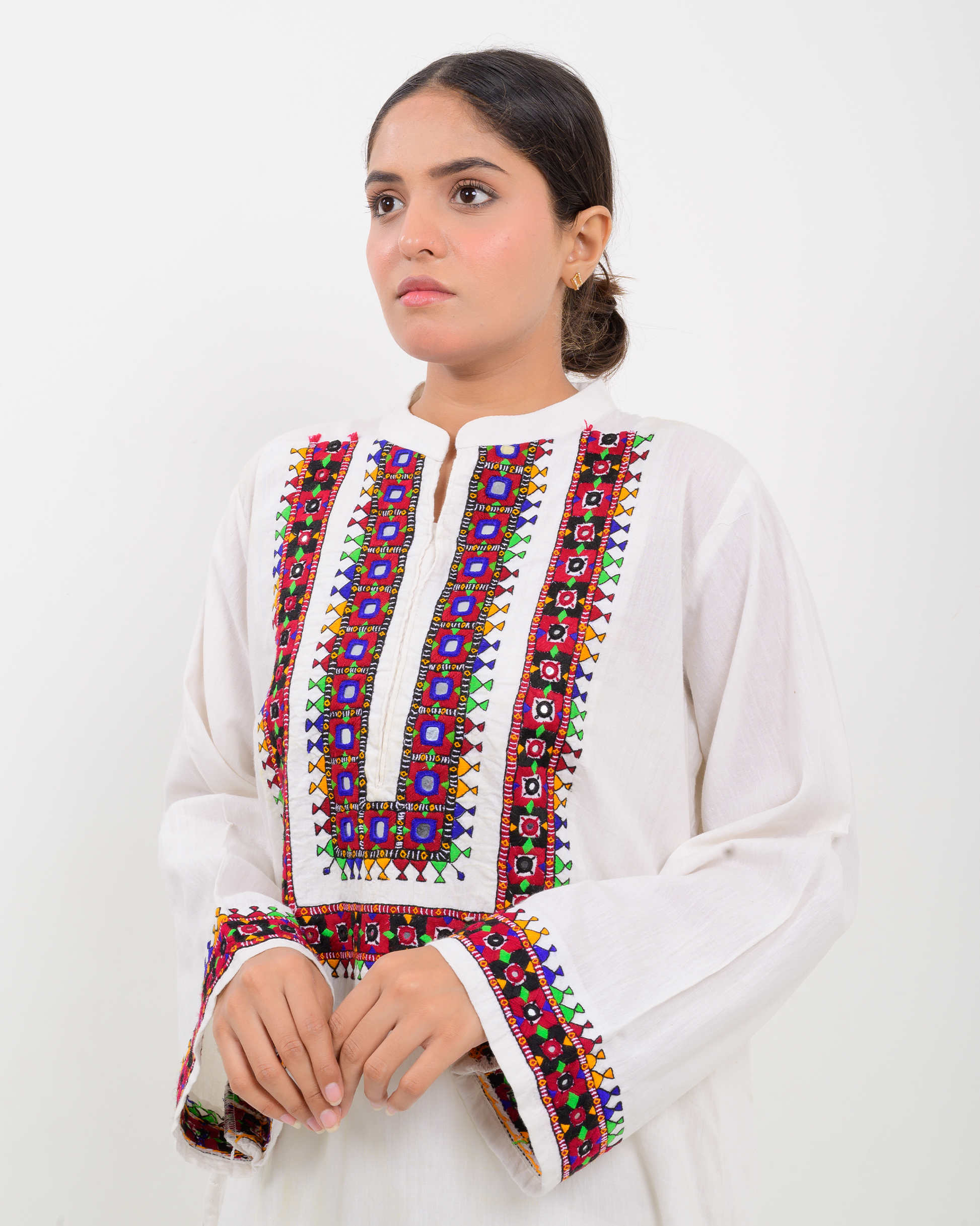 Woman wearing a white Balochi Embroidery Shirt with white plazo pants