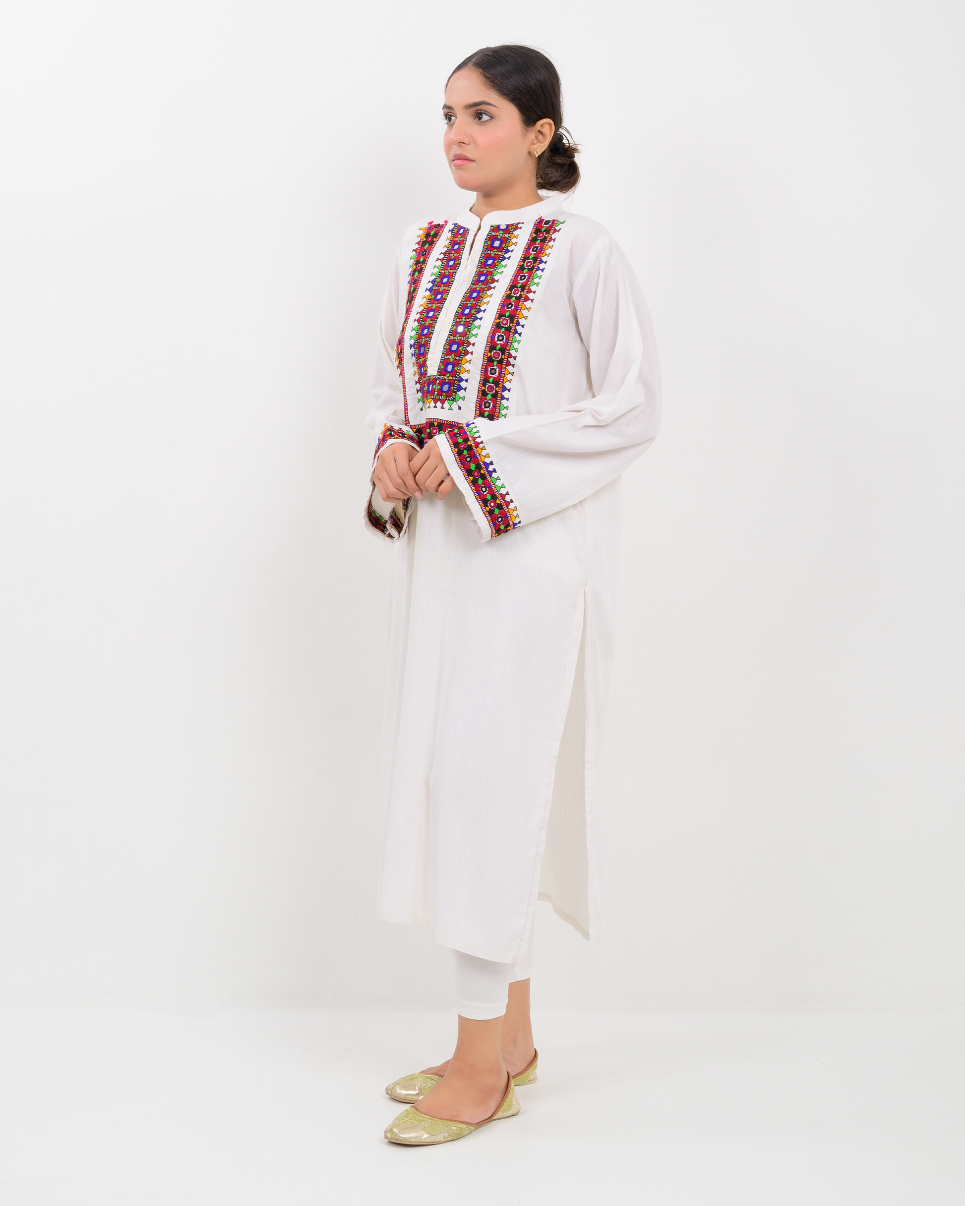 Woman wearing a white Balochi Embroidery Shirt with white plazo pants