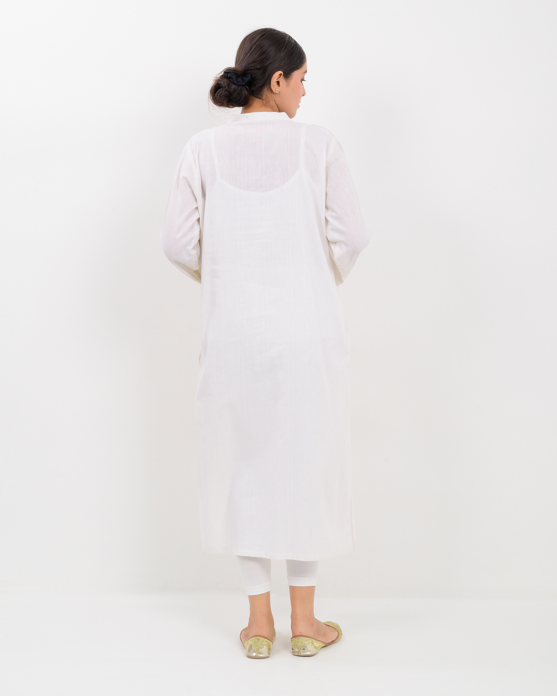 Woman wearing a white Balochi Embroidery Shirt with white plazo pants
