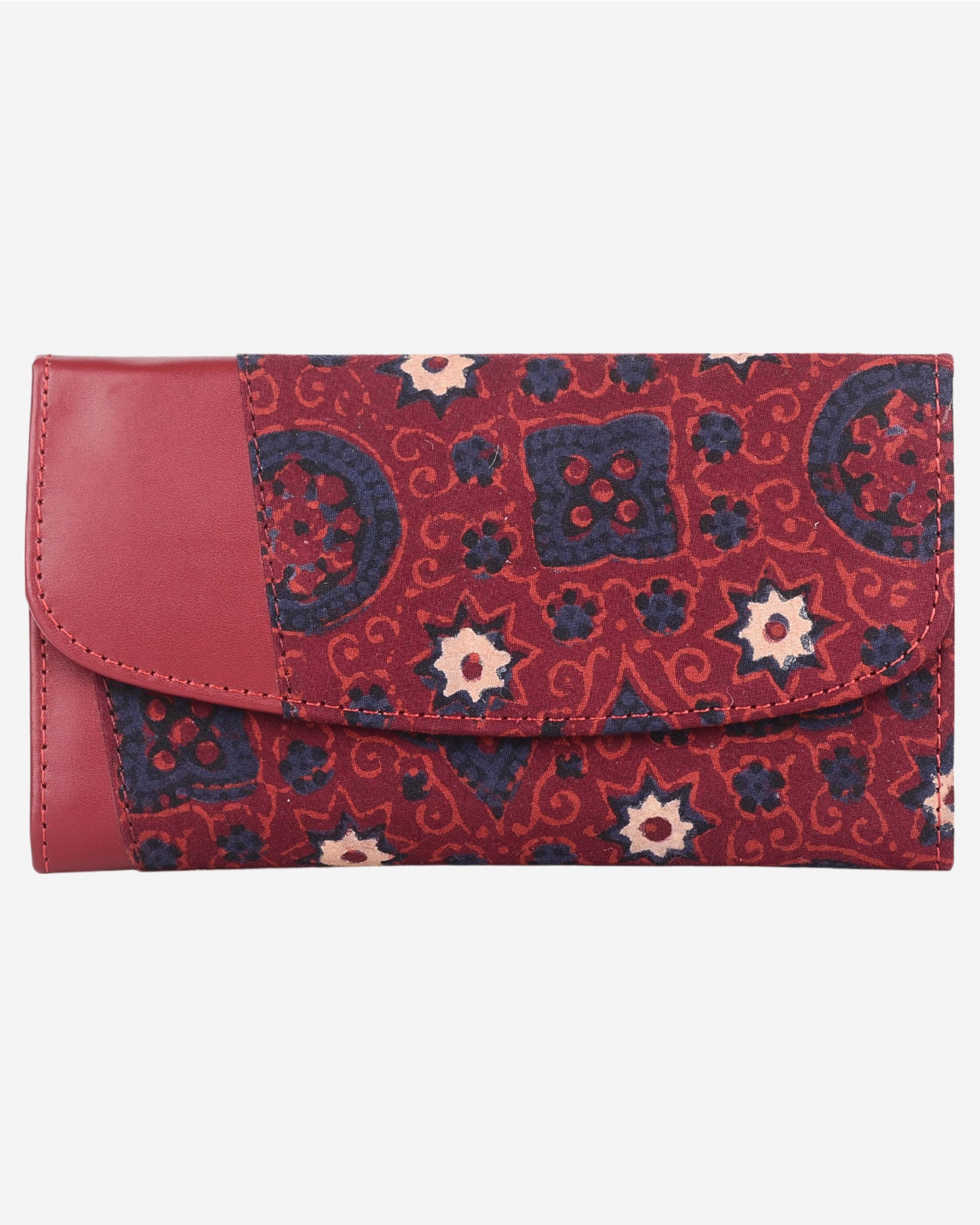 Red and blue patterned clutch bag with a leather flap on a white background