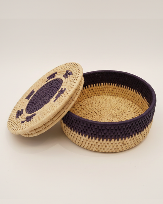 Woven basket with a lid on a light beige background