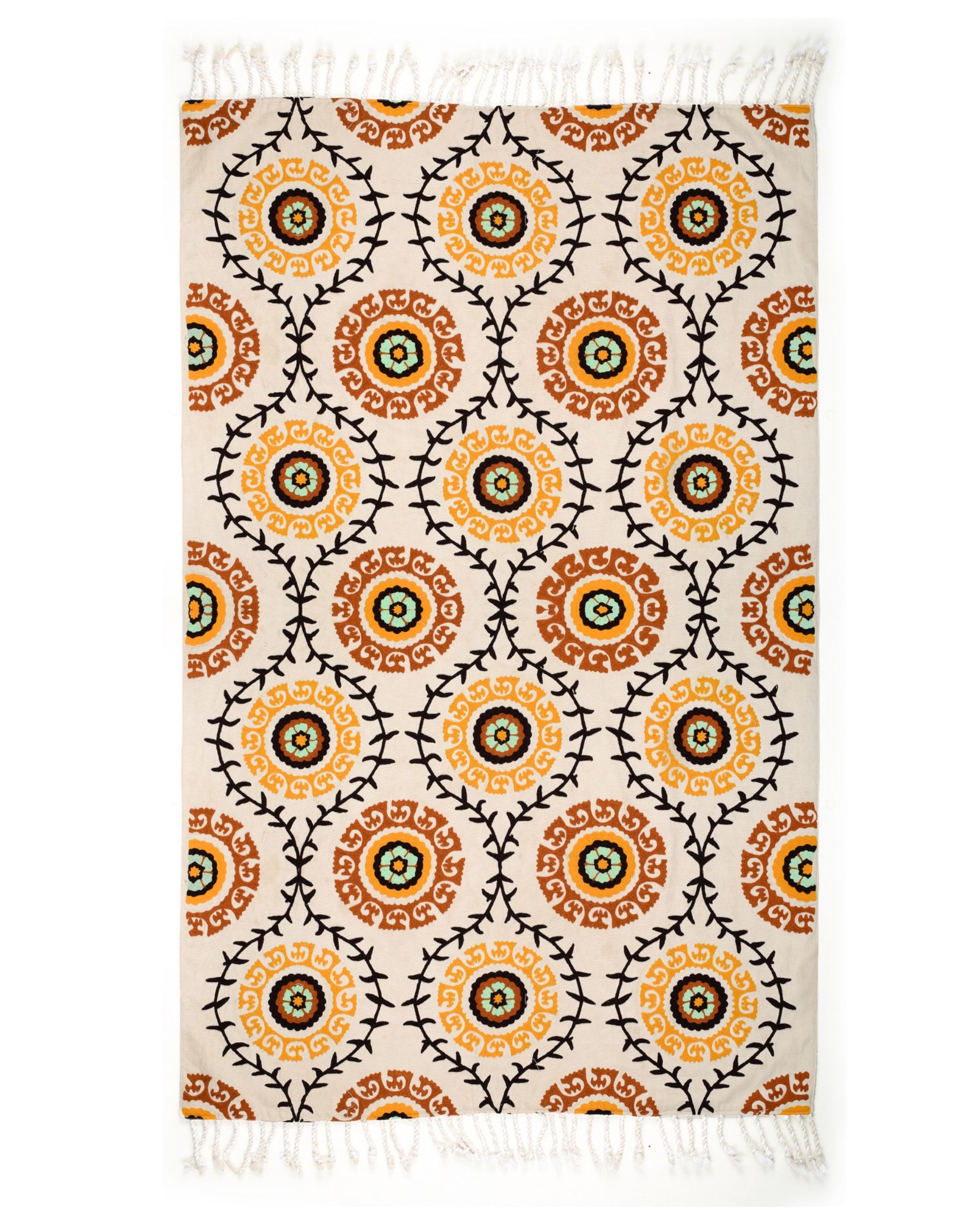 Patterned rug with orange and black circles on a white background