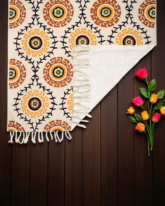 Patterned rug with orange and black circles on a white background