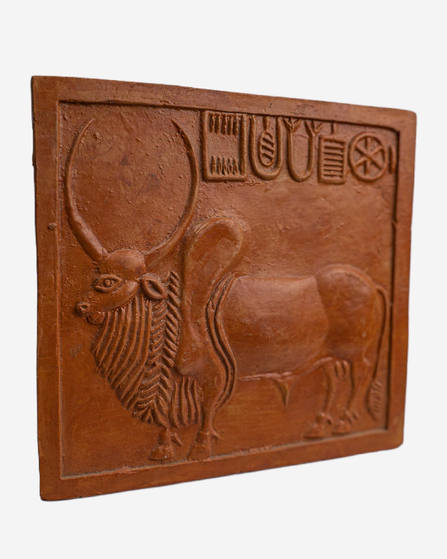 Terracotta tile with a bull design and ancient script, Clay Sculpture. Mohen-Jo-Daro Ancient Seal Clay