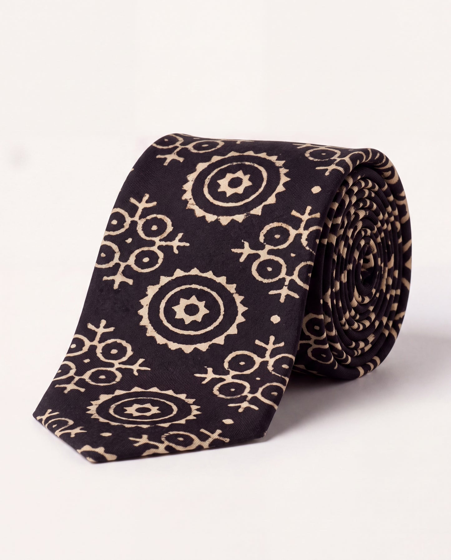 Lunar Eclipse natural dye Ajrak hand block print cotton tie in black with ivory geometric motifs, handcrafted by artisans in Sindh, Pakistan.
