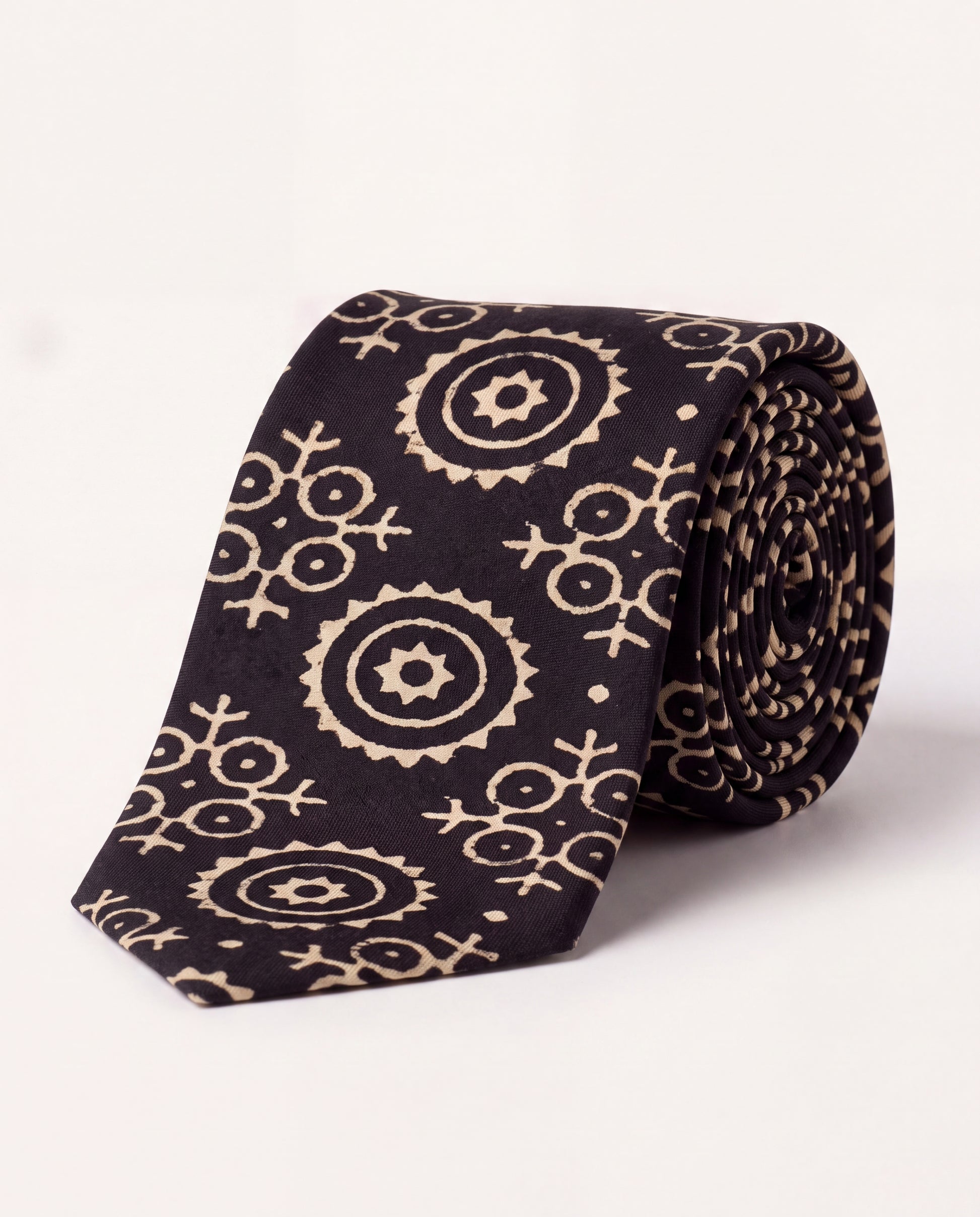Lunar Eclipse natural dye Ajrak hand block print cotton tie in black with ivory geometric motifs, handcrafted by artisans in Sindh, Pakistan.