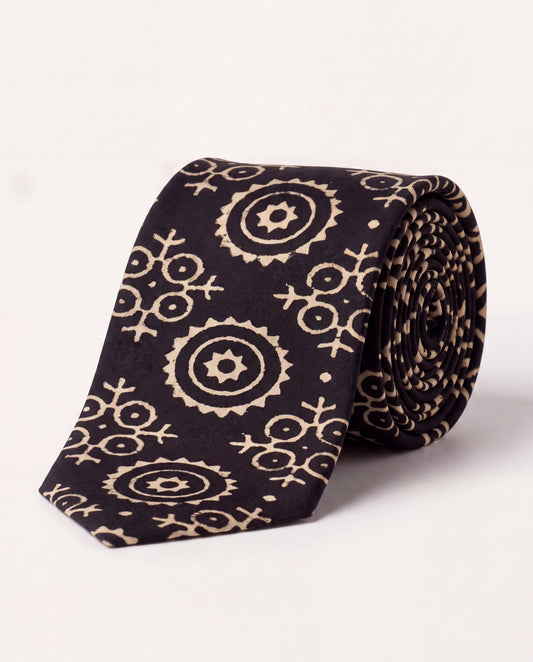 Lunar Eclipse natural dye Ajrak hand block print cotton tie in black with ivory geometric motifs, handcrafted by artisans in Sindh, Pakistan.