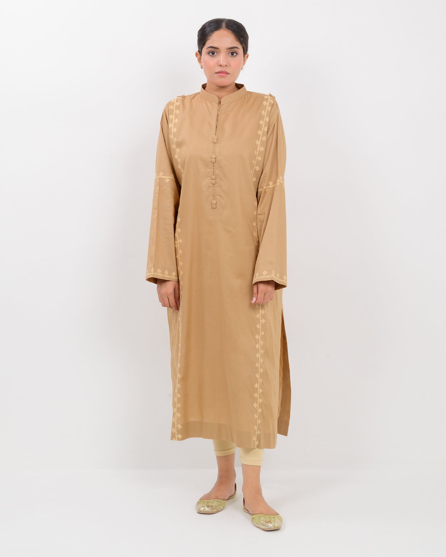 Woman wearing a beige Hurmich Embroidery shirt on white background