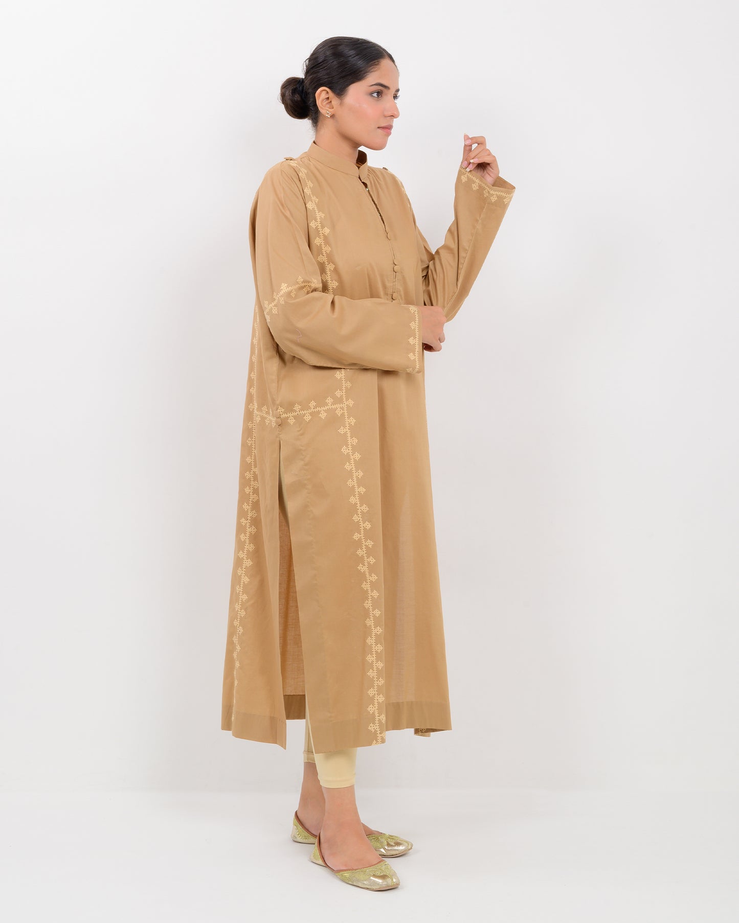 Woman wearing a beige Hurmich Embroidery shirt on white background