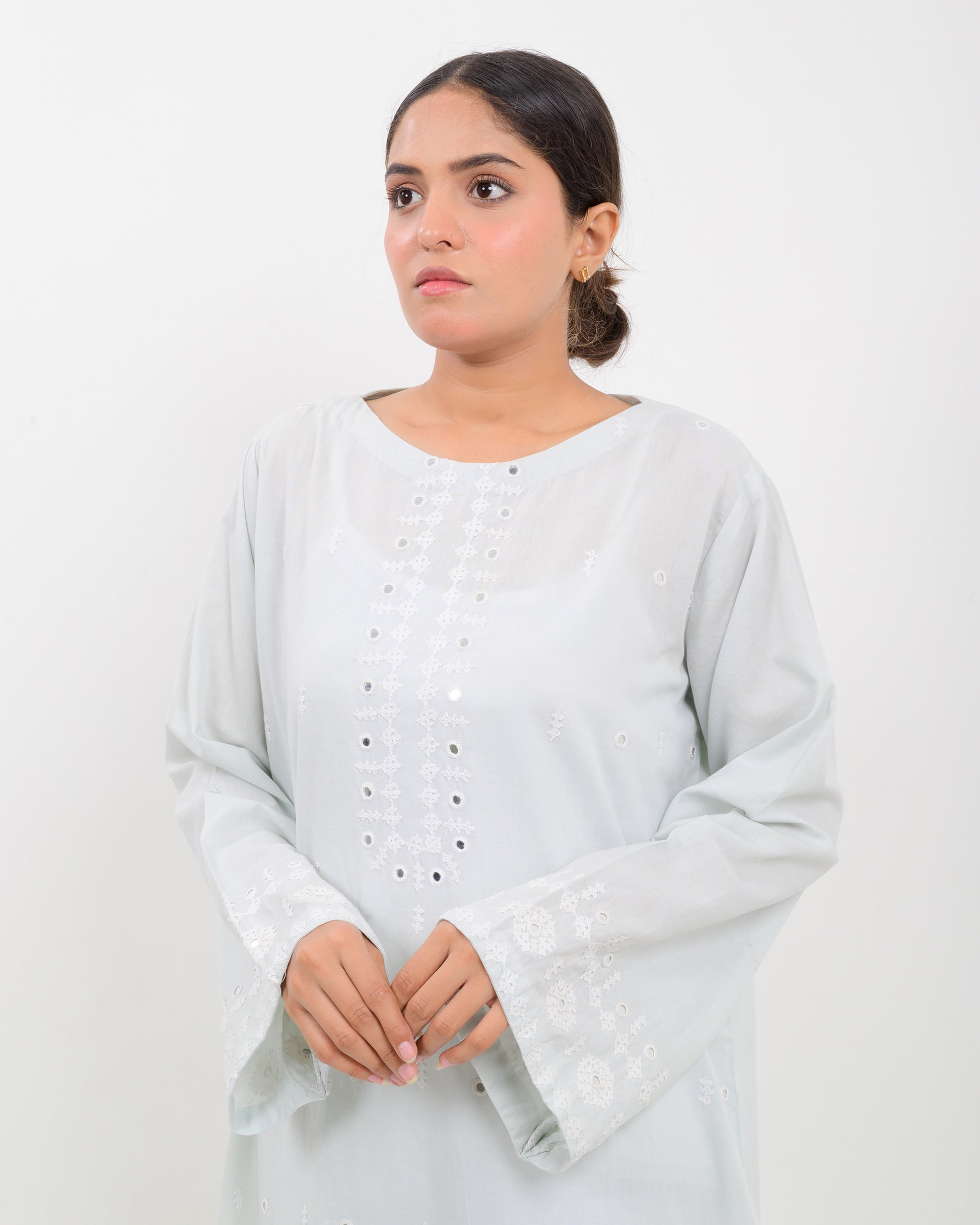 Woman wearing a white hurmich mirror work lawn shirt on a white background