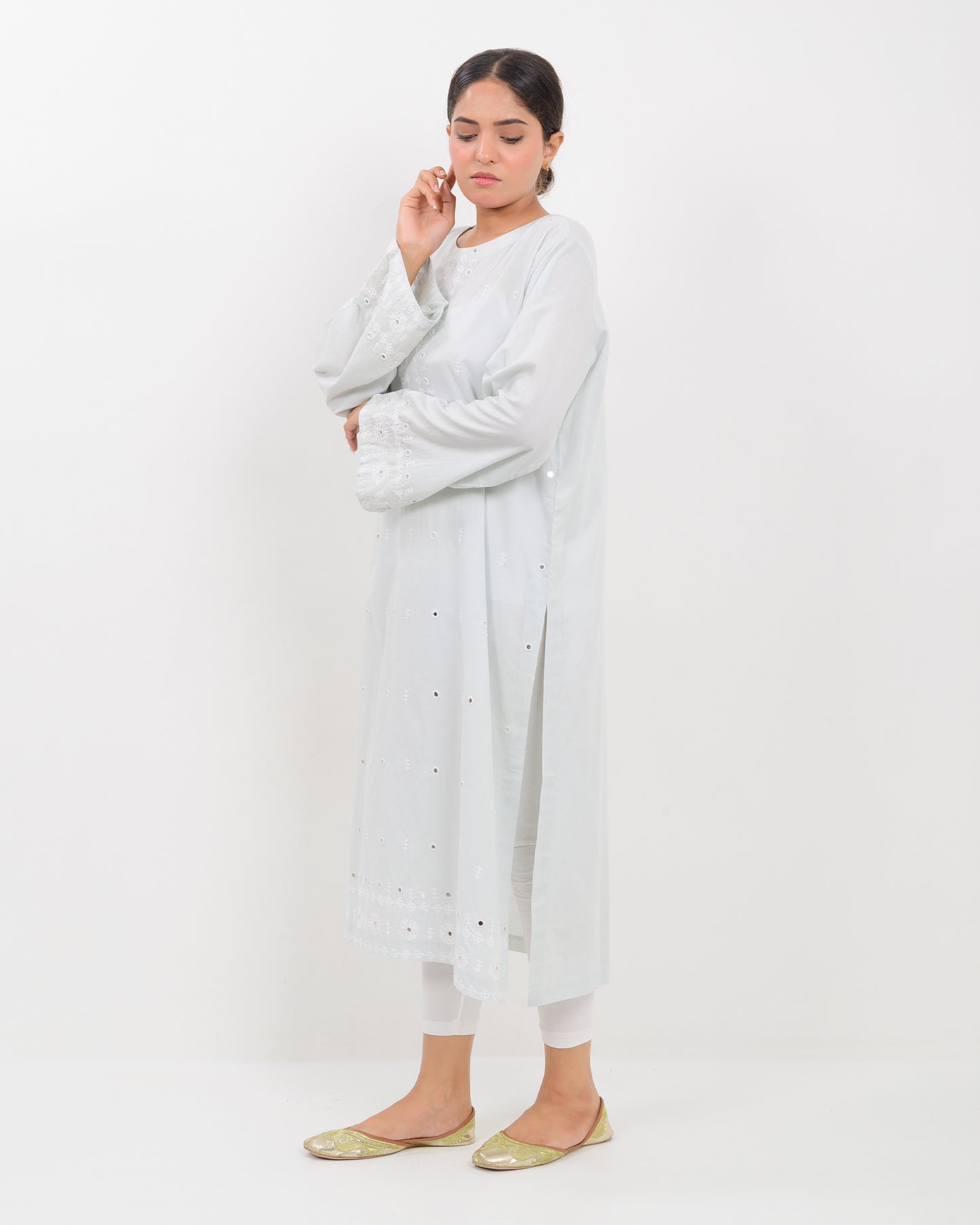 Woman wearing a white hurmich mirror work lawn shirt on a white background