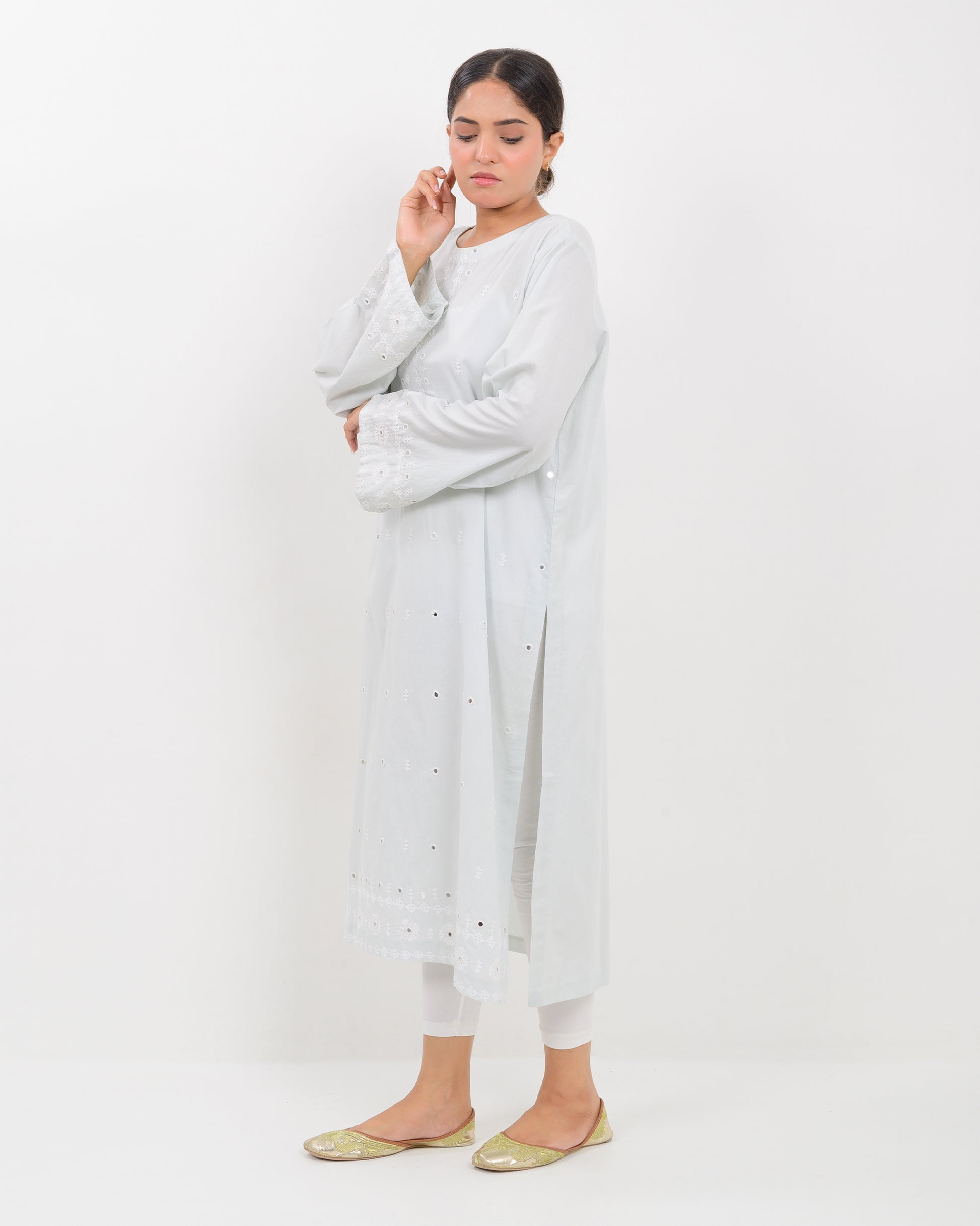 Woman wearing a white hurmich mirror work lawn shirt on a white background