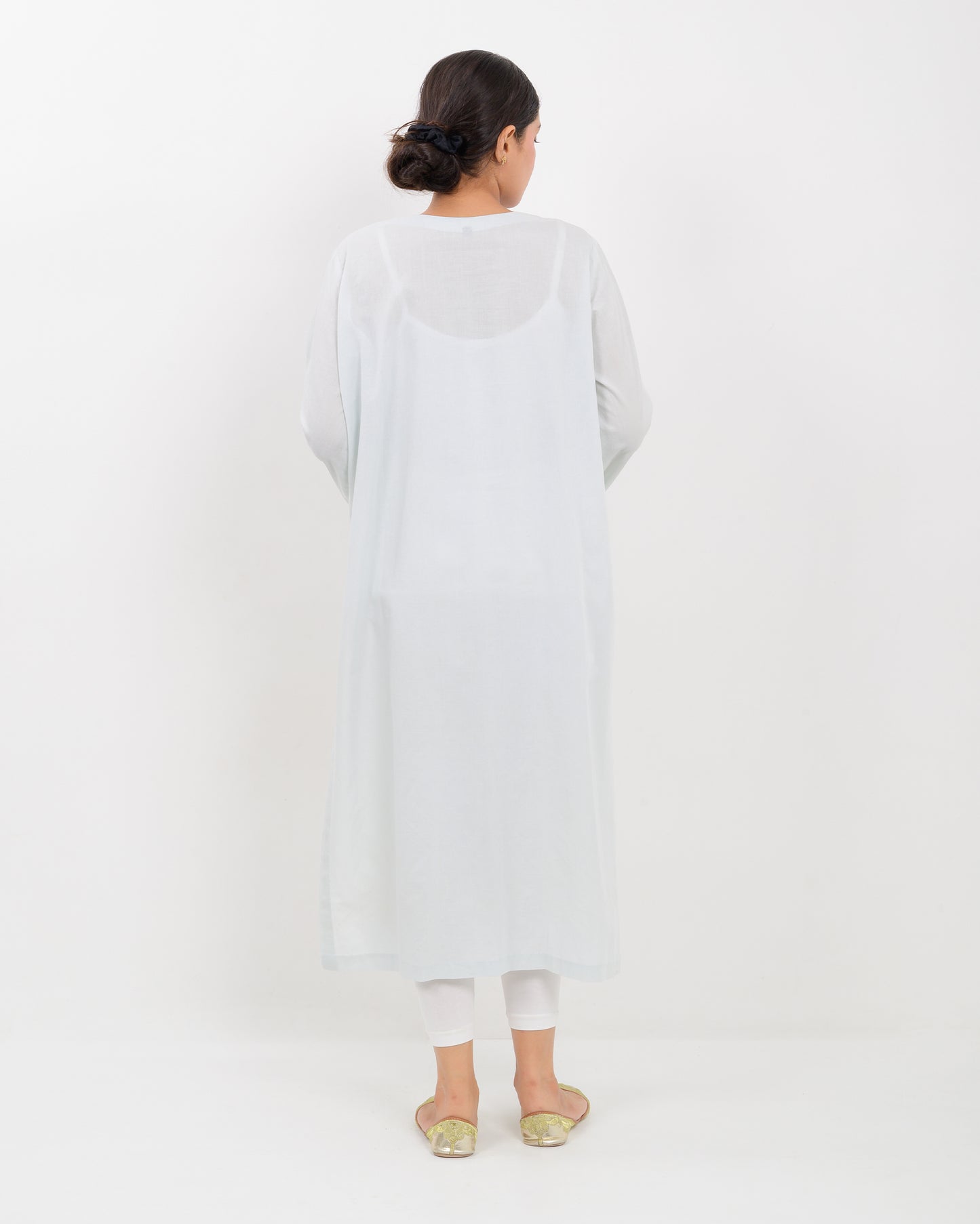 Woman wearing a white hurmich mirror work lawn shirt on a white background