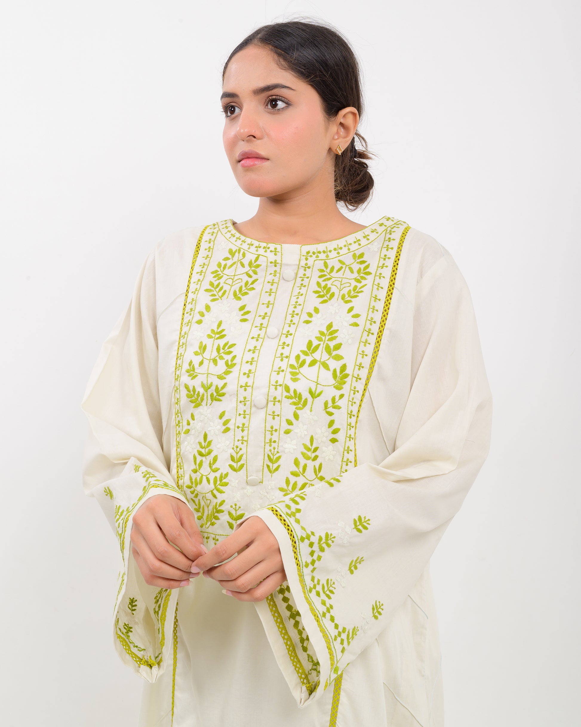 Woman wearing a light green kachi sui embroidery shirt on a white background
