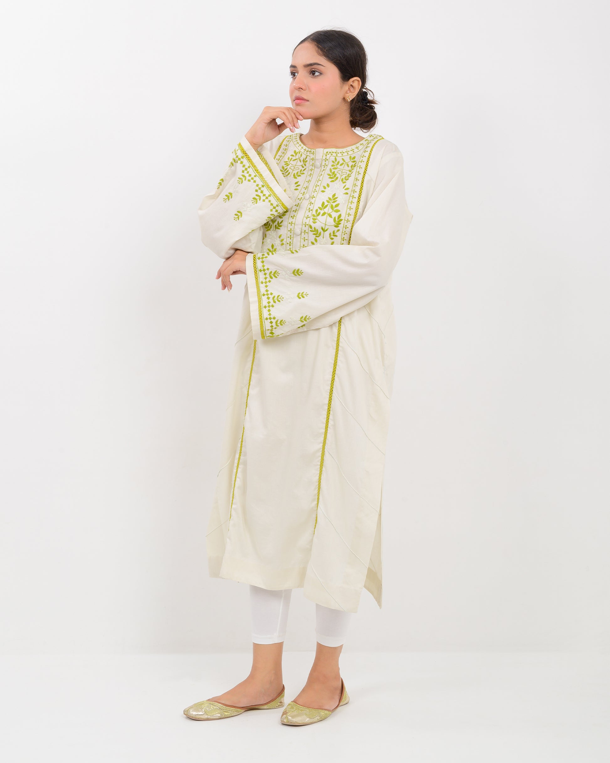 Woman wearing a light green kachi sui embroidery shirt on a white background