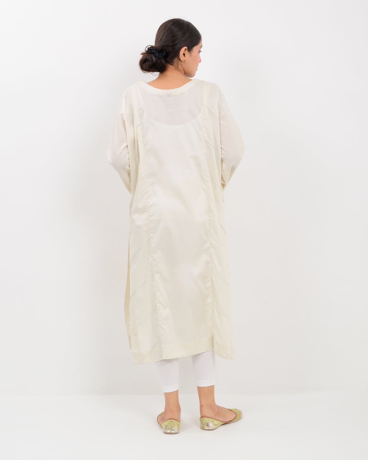Woman wearing a light green kachi sui embroidery shirt on a white background
