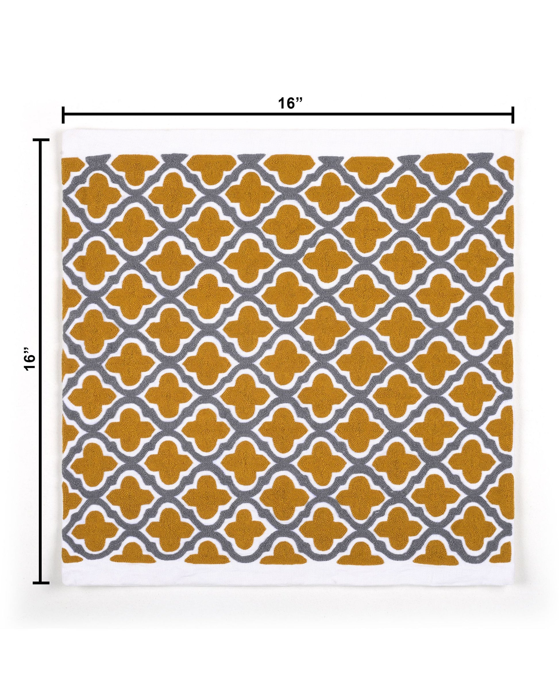 Decorative pillow with yellow and gray pattern on a gray sofa