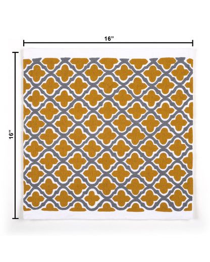 Decorative pillow with yellow and gray pattern on a gray sofa