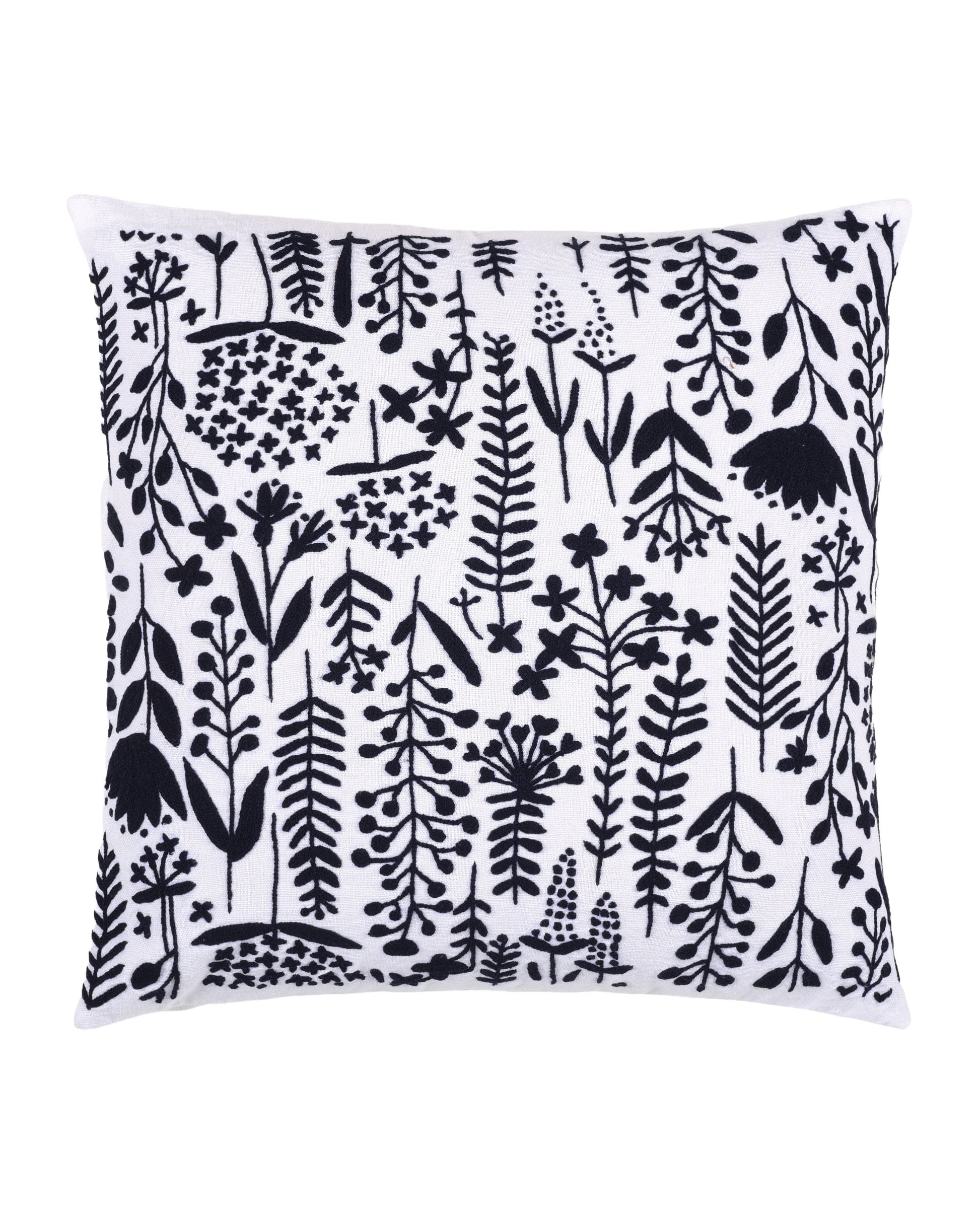 Cushion cover with black floral pattern on white background